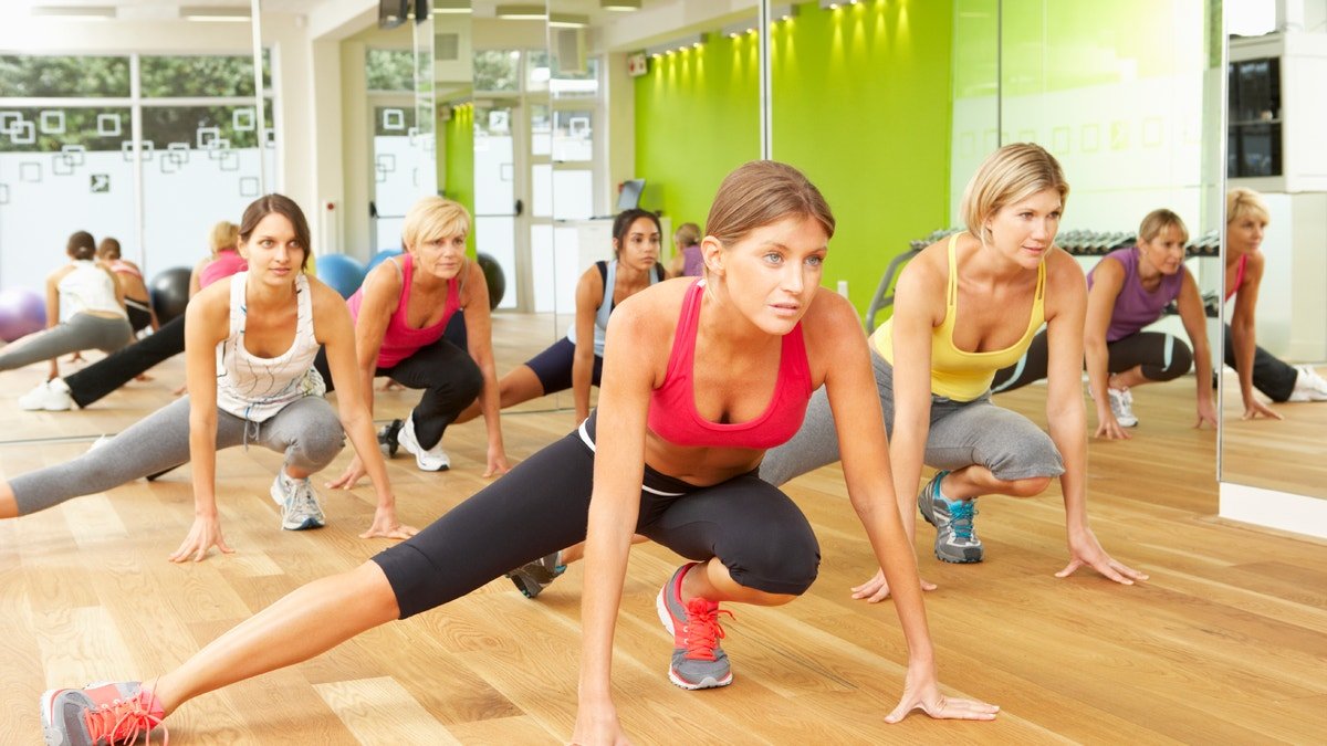 Women Taking Part In Gym Fitness Class